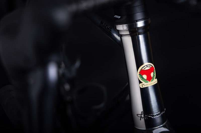 Detail of a polished MACH head tube with the enamelled Tommasini head badge